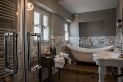a bathroom with a tub and a sink and a bath tub at Kyria Boutique House in Athens