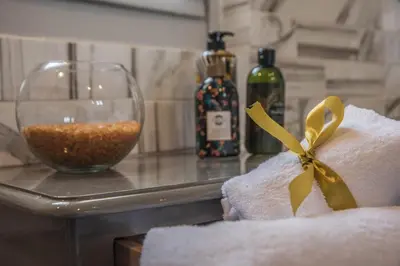 a towel on a counter next to a glass of wine at Kyria Boutique House in Athens