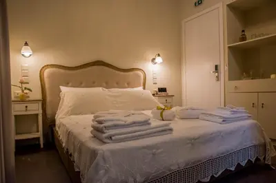 a bedroom with a bed with towels on it at Kyria Boutique House in Athens