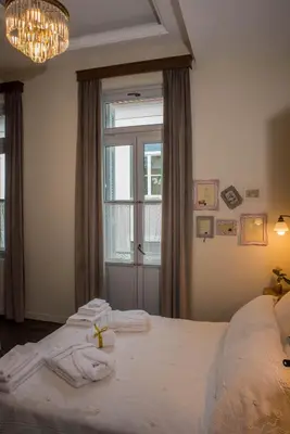 a bedroom with a large bed with a cross on it at Kyria Boutique House in Athens