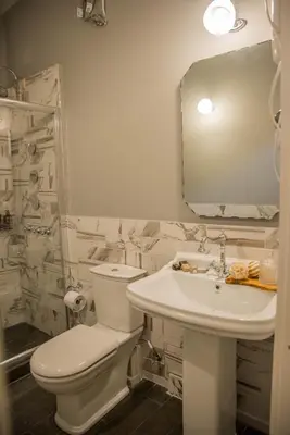 a bathroom with a toilet and a sink and a mirror at Kyria Boutique House in Athens