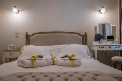 a bed with two towels with bananas on it at Kyria Boutique House in Athens