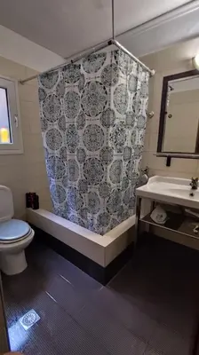 a bathroom with a toilet and a sink and a mirror at Near Airport And metropolitan Artemis George Cozy Home in Artemida