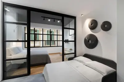 a bedroom with a bed and a large window at La Maison Athenes in Athens