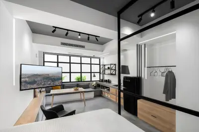 a bedroom with white walls and a large window at La Maison Athenes in Athens