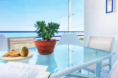 a glass table with a potted plant on top of it at A gem next to the sea and close to the airport in Dhaskalión