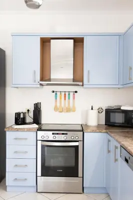 a kitchen with white cabinets and a stainless steel oven at Luxury and Spacious apt for 8 guests New features April 2025 in Athens