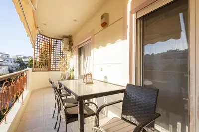 a dining room with a table and chairs on a balcony at Luxury and Spacious apt for 8 guests New features April 2025 in Athens