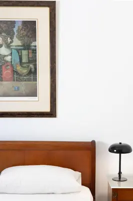 a bedroom with a bed with a picture on the wall at Luxury and Spacious apt for 8 guests New features April 2025 in Athens