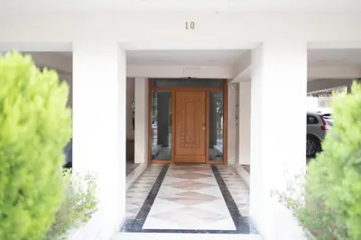 a front door of a house with trees at Luxury and Spacious apt for 8 guests New features April 2025 in Athens