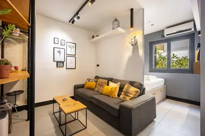 a living room with a couch and a window at Well Designed 1BR in Prime Kolonaki in Athens