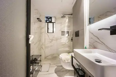 a white bathroom with a sink and a shower at Well Designed 1BR in Prime Kolonaki in Athens