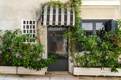 an entrance to a house with a black door and plants at Well Designed 1BR in Prime Kolonaki in Athens