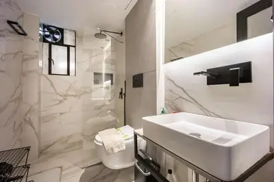 a white bathroom with a sink and a toilet at Well Designed 1BR in Prime Kolonaki in Athens