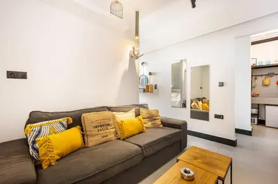a living room with a brown couch and yellow pillows at Well Designed 1BR in Prime Kolonaki in Athens