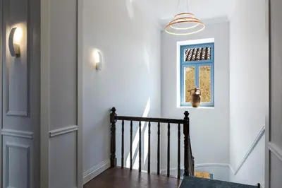 a hallway with a staircase with a window at A77 Suites, Small Luxury Hotels of the World in Athens