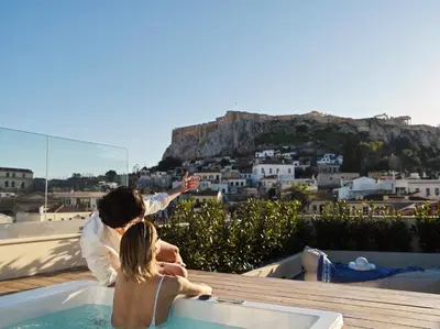 a woman and a child sitting in a bath tub at A77 Suites, Small Luxury Hotels of the World in Athens