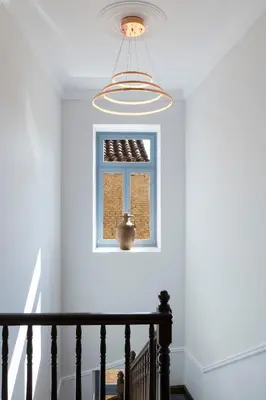 a staircase with a window and a light fixture at A77 Suites, Small Luxury Hotels of the World in Athens