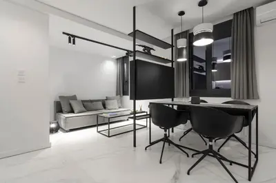 a living room with a black table and chairs at Heritage Boutique Apartments in Athens