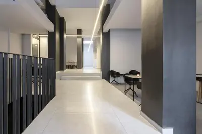 a hallway with a table and chairs in a building at Heritage Boutique Apartments in Athens