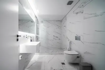 a white bathroom with a toilet and a sink at Heritage Boutique Apartments in Athens
