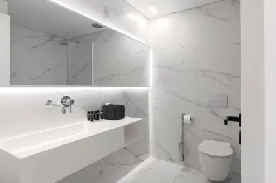 a white bathroom with a sink and a toilet at Heritage Boutique Apartments in Athens