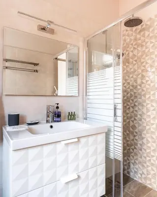 a bathroom with a white sink and a shower at Monastiraki Urban Apartments in Athens