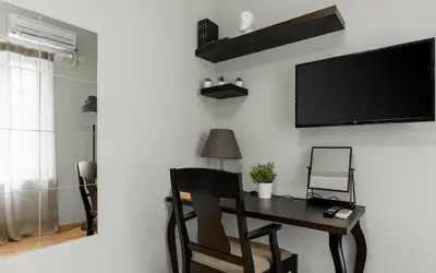 a room with a desk and a tv on a wall at Monastiraki Urban Apartments in Athens