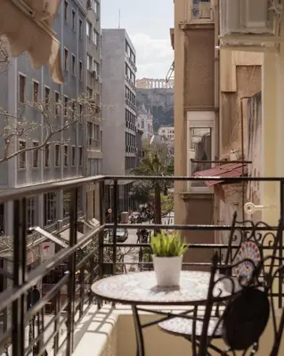 a patio with a table and chairs on a balcony at Monastiraki Urban Apartments in Athens
