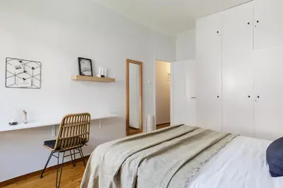 a bedroom with a bed and a chair and a desk at Urban 2BD Apartment in Koukaki by UPSTREET in Athens