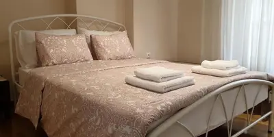 a bed with white towels on top of it at Koukaki apartment near Acropolis in Athens