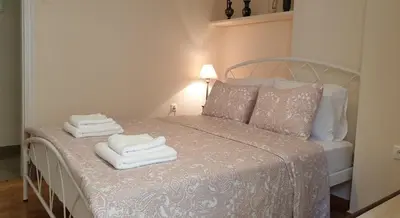 a bedroom with a bed with towels on it at Koukaki apartment near Acropolis in Athens