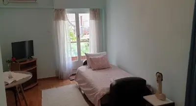 a small bedroom with a bed and a window at Koukaki apartment near Acropolis in Athens