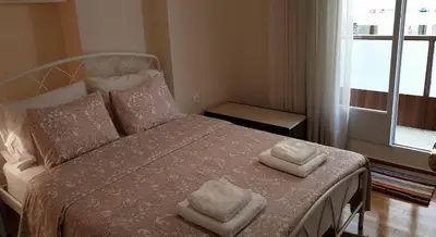 a bedroom with a bed with two towels on it at Koukaki apartment near Acropolis in Athens