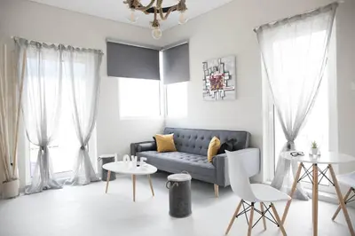 a living room with a couch and a table at Breathtaking view penthouse at the heart of Thiseio, VP homes in Athens