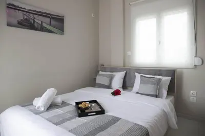 a white bed with a tray of food on it at Breathtaking view penthouse at the heart of Thiseio, VP homes in Athens