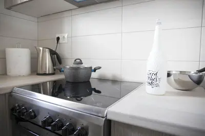 a kitchen with a stove with a pot on it at Breathtaking view penthouse at the heart of Thiseio, VP homes in Athens