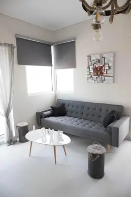 a living room with a couch and a table at Breathtaking view penthouse at the heart of Thiseio, VP homes in Athens