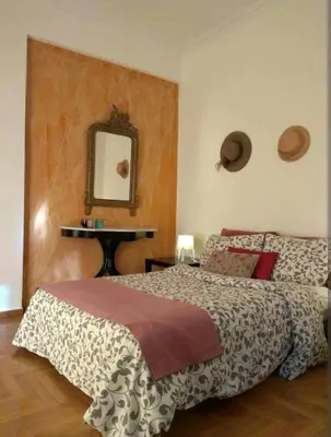 a bedroom with a bed and a mirror on the wall at Zizi room in Athens