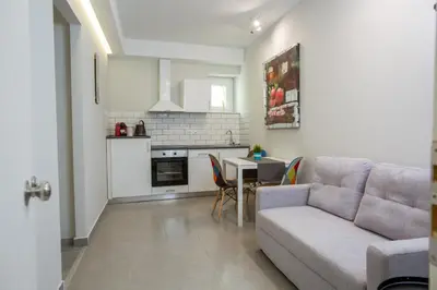 a living room with a couch and a table at Raise Boutique Rooms in the Center of Athens in Athens