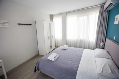 a bedroom with a bed with two towels on it at Raise Boutique Rooms in the Center of Athens in Athens
