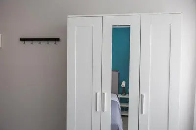 a bedroom with white cabinets and a bed at Raise Boutique Rooms in the Center of Athens in Athens