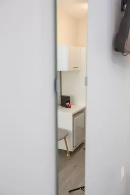 a room with a desk and a table with a chair at Raise Boutique Rooms in the Center of Athens in Athens