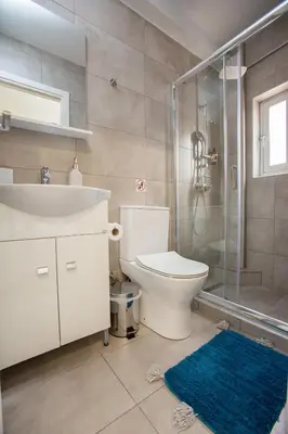 a bathroom with a sink and a toilet and a shower at Raise Boutique Rooms in the Center of Athens in Athens