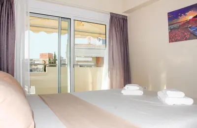 a bedroom with a bed with two towels on it at Charming Apartment near Athens Center and the Sea in Athens