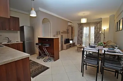 a kitchen and living room with a table and chairs at Charming Apartment near Athens Center and the Sea in Athens