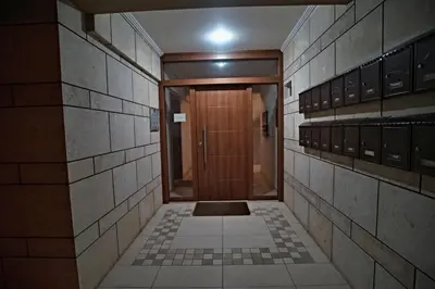 a hallway with a wooden door in a building at Charming Apartment near Athens Center and the Sea in Athens