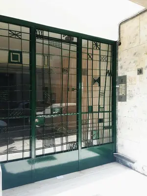 an entrance to a building with glass doors at Prime Location 2 BR APT next to the Acropolis in Athens