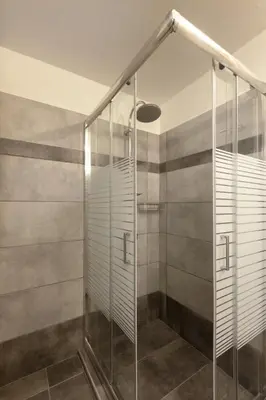 a shower stall with glass doors in a bathroom at Prime Location 2 BR APT next to the Acropolis in Athens