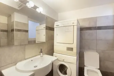 a bathroom with a sink and a washing machine at Prime Location 2 BR APT next to the Acropolis in Athens